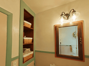 Elegant bathroom mirror with lighting in Blue Mountain Bathrooms home renovation.