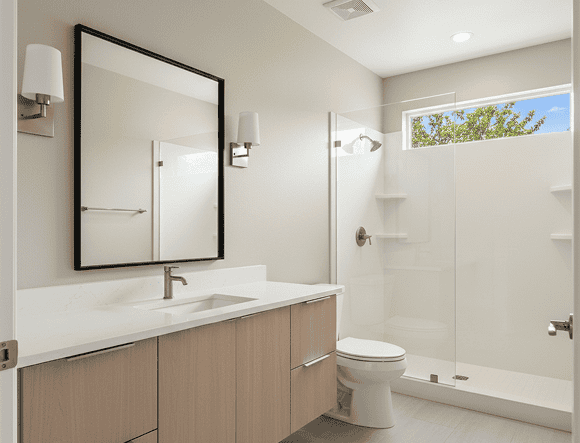 Bright modern bathroom with walk-in shower, vanity, and natural light.