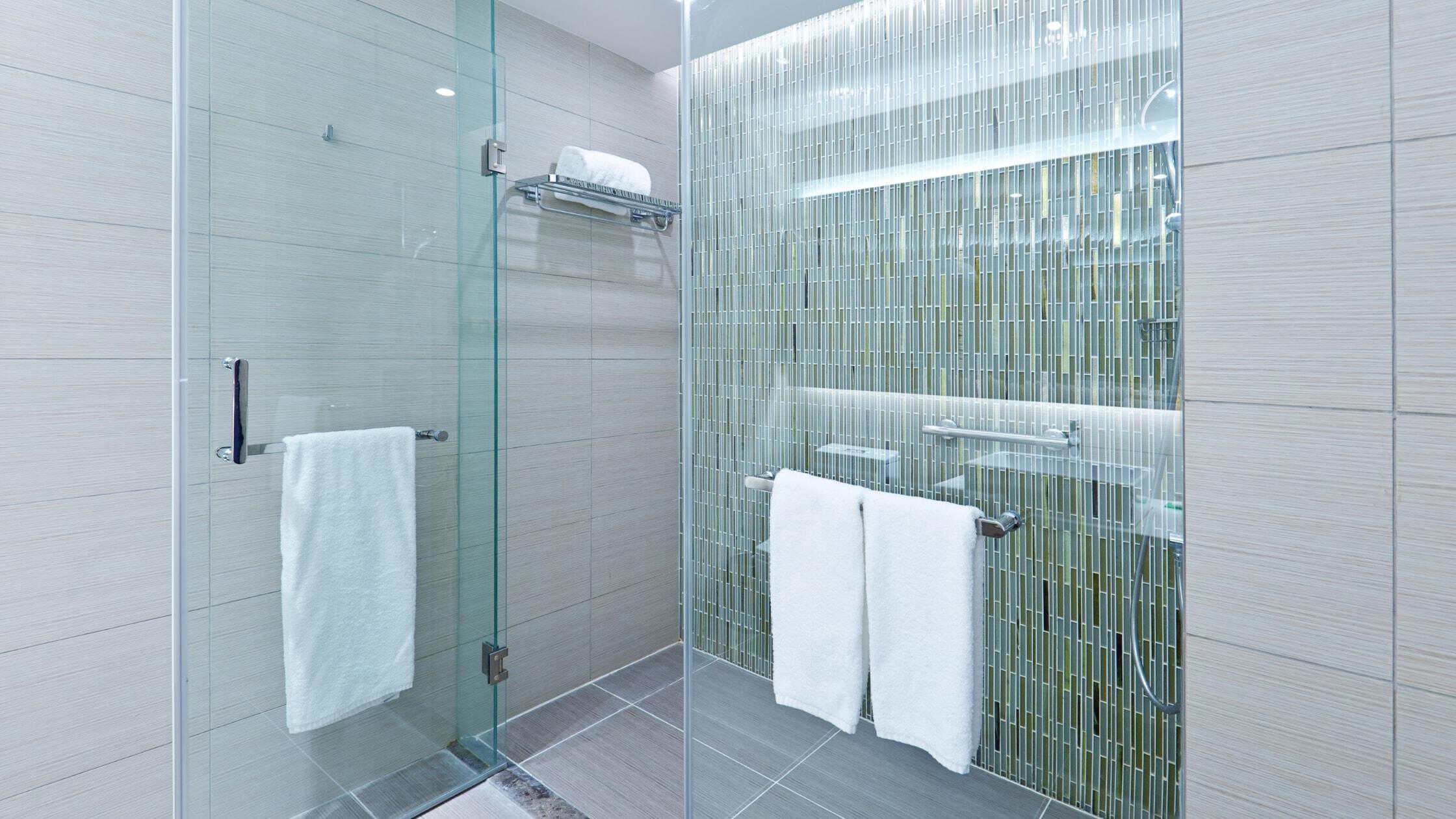 Modern Bathroom Shower Modern bathroom shower with glass enclosure and green mosaic tile accent wall.