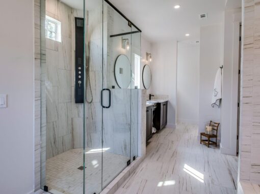 Luxury walk-in shower with glass enclosure and sleek fixtures.