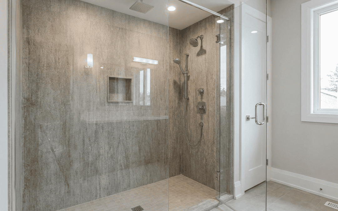 Modern walk-in shower with glass enclosure and beige tile walls at Blue Mountain Bathrooms.